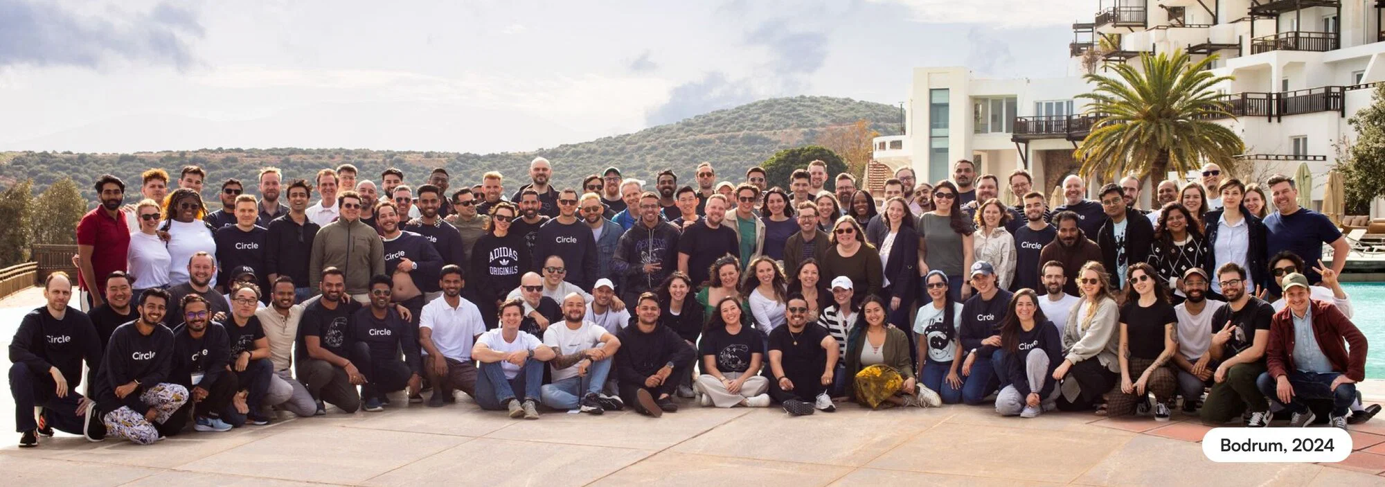 Circle teammates together at a company offsite