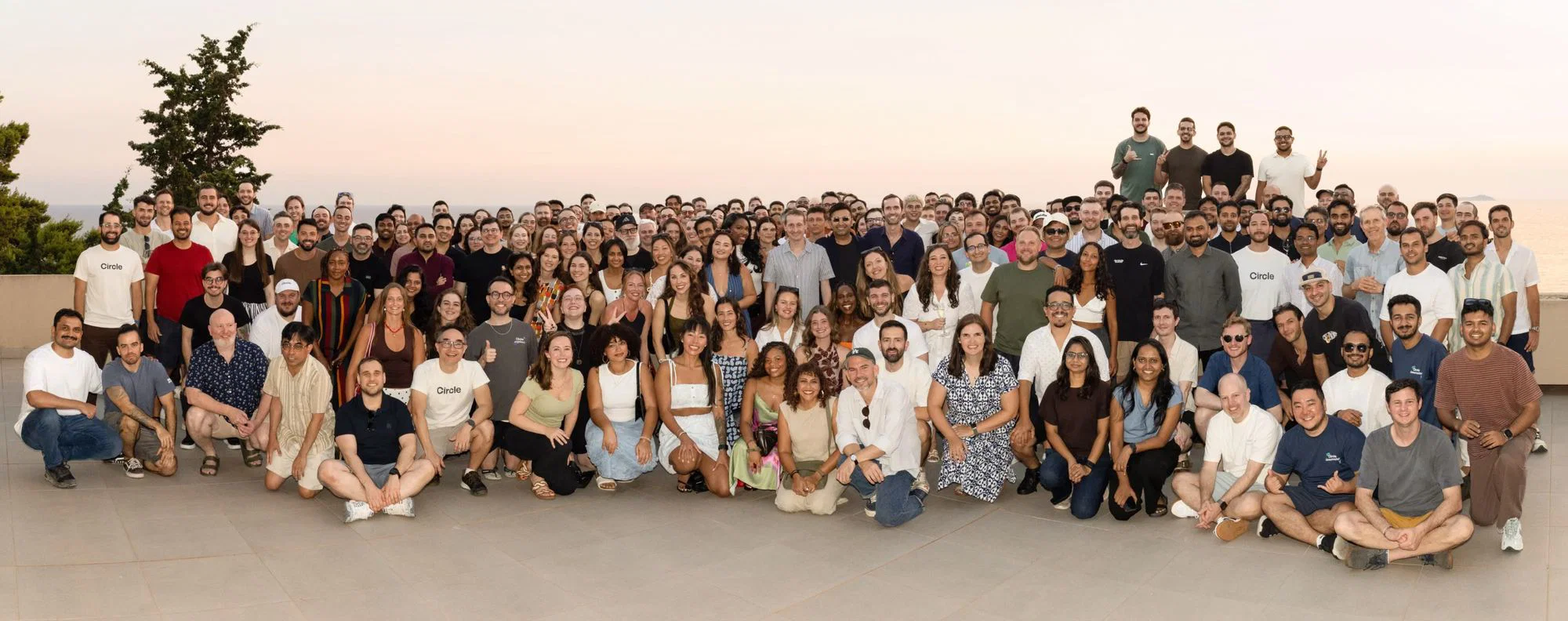 The Circle team gathered on a terrace at sunset in Dubrovnik